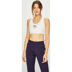Calvin Klein Performance - Biustonosz. Białe biustonosze sportowe damskie Calvin Klein Performance, s, z nadrukiem, z elastanu. W wyprzedaży za 159,90 zł.