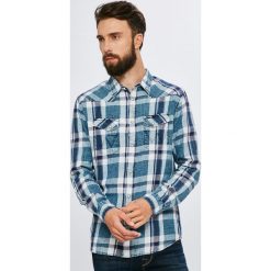 Wrangler - Koszula. Niebieskie koszule męskie na spinki marki Wrangler, m, z bawełny, klasyczne, z klasycznym kołnierzykiem, z długim rękawem. W wyprzedaży za 139,90 zł.