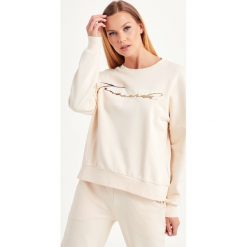 BLUZA TRUSSARDI JEANS. Żółte bluzy damskie Trussardi Jeans, xl, z nadrukiem, z elastanu, bez rękawów, bez kaptura. Za 369,00 zł.