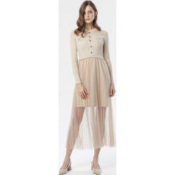 Beżowa Sukienka Heila. Brązowe sukienki damskie Born2be, s, bez wzorów, z dzianiny, eleganckie, z okrągłym kołnierzem, z długim rękawem, długie, midi, rozkloszowane. Za 149,99 zł.