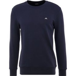 J.LINDEBERG THROW RING LOOP Bluza navy. Niebieskie bluzy męskie marki J.LINDEBERG, s, bez wzorów, z bawełny, bez kołnierzyka, bez rękawów, bez kaptura. Za 459,00 zł.