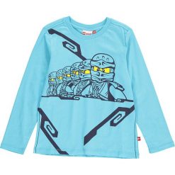 Koszulka "Thomas 309" w kolorze turkusowym. Niebieskie t-shirty chłopięce marki LEGO Wear, z nadrukiem, z bawełny, z długim rękawem. W wyprzedaży za 59,95 zł.