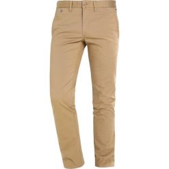 Tommy Jeans SLIM FERRY Chinosy beige. Brązowe jeansy męskie Tommy Jeans, z bawełny. Za 379,00 zł.
