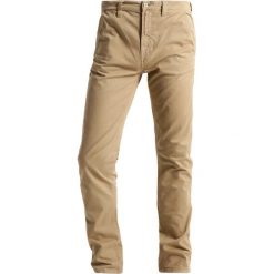 Nudie Jeans ADAM Chinosy beige. Brązowe jeansy męskie marki Nudie Jeans, m, bez wzorów, z elastanu. Za 579,00 zł.