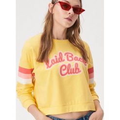 Bluza z kolorowym nadrukiem - Żółty. Żółte bluzy damskie Sinsay, xl, z nadrukiem, bez rękawów, bez kaptura. W wyprzedaży za 19,99 zł.