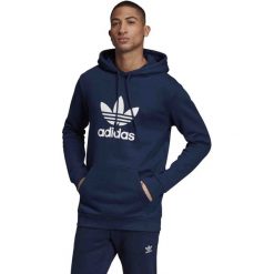 MĘSKA BLUZA ADIDAS ORIGINALS TREFOIL Z KAPTUREM (L). Niebieskie bluzy męskie Adidas, m, bez wzorów, z bawełny, z kapturem, bez rękawów, z kapturem. W wyprzedaży za 219,99 zł.