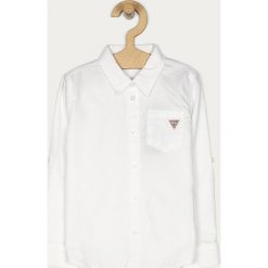 Guess Jeans - Koszula dziecięca 98-122 cm. Białe koszule chłopięce Guess Jeans, bez wzorów, z bawełny, eleganckie, z klasycznym kołnierzykiem, z długim rękawem, długie. W wyprzedaży za 139,90 zł.