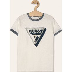 Guess Jeans - T-shirt dziecięcy 118-175 cm. Białe bluzki dziewczęce Guess Jeans, z nadrukiem, z bawełny, z okrągłym kołnierzem, z krótkim rękawem, krótkie, bez kaptura. W wyprzedaży za 99,90 zł.