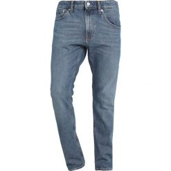 Calvin Klein Jeans 056 ATHLETIC TAPER Jeansy Zwężane blue denim. Niebieskie jeansy męskie marki Calvin Klein Jeans, z bawełny. Za 419,00 zł.