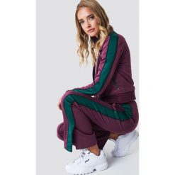 NA-KD Spodnie sportowe z rozcięciem - Purple. Fioletowe bryczesy damskie marki NA-KD, z poliesteru. Za 161,95 zł.