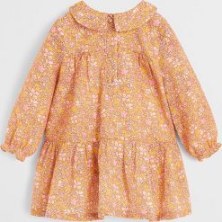 Mango Kids - Sukienka dziecięca 80-104 cm. Żółte sukienki dziewczęce Mango Kids, bez wzorów, z bawełny, casualowe, z długim rękawem, długie, mini, rozkloszowane. Za 99,90 zł.