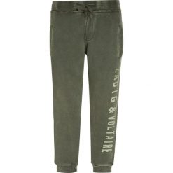 Zadig & Voltaire Spodnie treningowe kaki. Brązowe spodnie dresowe dziewczęce marki Zadig & Voltaire, z bawełny. W wyprzedaży za 202,30 zł.