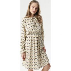 Kremowa Sukienka Elia. Brązowe sukienki damskie Born2be, na imprezę, xl, bez wzorów, eleganckie, bez kołnierzyka, bez rękawów, długie, midi. Za 69,99 zł.