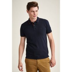 Koszulka polo w kolorze granatowym. Niebieskie koszulki męskie TATUUM, s, bez wzorów, z bawełny, bez rękawów. W wyprzedaży za 79,95 zł.