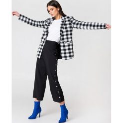 NA-KD Trend Spodnie z wysokim stanem i zatrzaskami - Black. Czarne spodnie z wysokim stanem marki NA-KD Trend, s, z haftami, z poliesteru, z podwyższonym stanem. W wyprzedaży za 64,78 zł.