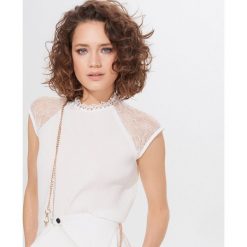 Elegancka bluzka ze stójką - Kremowy. Białe bluzki damskie Mohito, s, bez wzorów, eleganckie, ze stójką, bez rękawów. Za 79,99 zł.