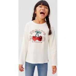Mango Kids - Longsleeve dziecięcy Mood 110-164 cm. Białe bluzki dziewczęce Mango Kids, z nadrukiem, z bawełny, z okrągłym kołnierzem, z krótkim rękawem, krótkie, bez kaptura. Za 49,90 zł.