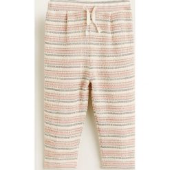 Mango Kids - Spodnie dziecięce Olivia 80-104 cm. Białe spodnie dziewczęce Mango Kids, bez wzorów, z bawełny, casualowe. Za 59,90 zł.