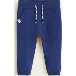 Mango Kids - Spodnie dziecięce Mateo 80-104 cm. Niebieskie spodnie chłopięce marki Mango Kids, bez wzorów, z bawełny, casualowe. Za 35,90 zł.