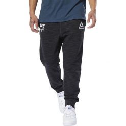 MĘSKIE SPODNIE DRESOWE UFC FAN GEAR (L). Spodnie męskie Reebok, m, bez wzorów, z bawełny. W wyprzedaży za 179,99 zł.