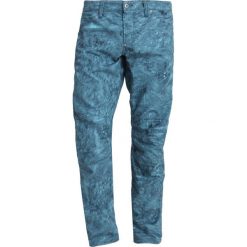 GStar PHARRELL WILLIAMS ELWOOD Spodnie materiałowe indigo/lake. Niebieskie spodnie męskie marki G-Star, m, bez wzorów, z bawełny. Za 559,00 zł.
