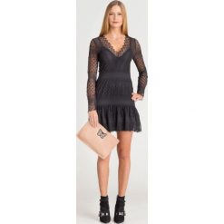 SUKIENKA KAROL GUESS. Czarne sukienki damskie Guess, na imprezę, s, z aplikacjami, z nylonu, z włoskim kołnierzykiem, bez rękawów, mini. Za 407,40 zł.