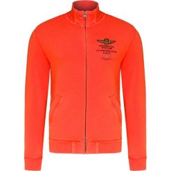 Bluza AERONAUTICA MILITARE. Pomarańczowe bluzy męskie Aeronautica Militare, bez wzorów, z dzianiny, ze stójką, bez rękawów, bez kaptura. W wyprzedaży za 511,00 zł.