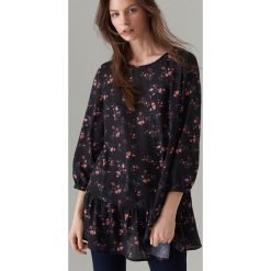 Bluzka oversize z falbaną - Czarny. Czarne bluzki damskie Mohito, bez wzorów, bez kołnierzyka, bez rękawów. W wyprzedaży za 59,99 zł.