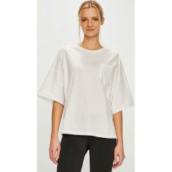 Reebok - Top. Białe topy damskie Reebok, s, bez wzorów, z elastanu, z okrągłym kołnierzem. W wyprzedaży za 129,90 zł.