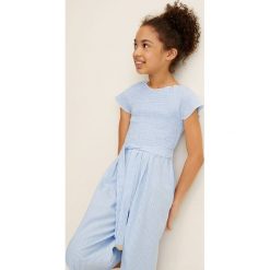 Mango Kids - Kombinezon dziecięcy Pape 110-164 cm. Niebieskie kombinezony dziewczęce Mango Kids, bez wzorów, z bawełny, z krótkim rękawem, krótkie. Za 129,90 zł.