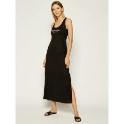 Sukienka plażowa Calvin Klein Swimwear KW0KW01080. Czarne sukienki damskie Calvin Klein Swimwear, na plażę, na lato, l, bez wzorów, bez kołnierzyka, bez rękawów. W wyprzedaży za 269,00 zł.