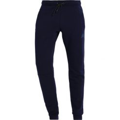 Spodnie dresowe męskie: New Balance ATHLETICS Spodnie treningowe pigment