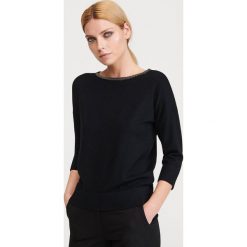 Sweter z aplikacją przy dekolcie - Czarny. Czarne swetry damskie Reserved, s, z aplikacjami, bez rękawów, bez kaptura. Za 79,99 zł.