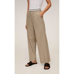 Mango - Spodnie Rubber. Pomarańczowe spodnie damskie Mango, s, bez wzorów, z elastanu. Za 139,90 zł.