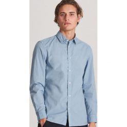 Bawełniana koszula regular fit - Niebieski. Niebieskie koszule męskie Reserved, s, bez wzorów, z bawełny, bez kołnierzyka, bez rękawów. W wyprzedaży za 59,99 zł.
