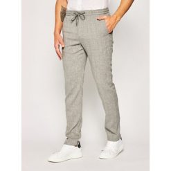Spodnie materiałowe Tommy Hilfiger Tailored Drawstring TT0TT07204. Niebieskie jeansy męskie Tommy Hilfiger Tailored, m, bez wzorów, z poliesteru. W wyprzedaży za 399,00 zł.