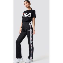 FILA Spodnie Thora Track - Black. Czarne spodnie z wysokim stanem marki Fila, w paski, z podwyższonym stanem. Za 283,95 zł.