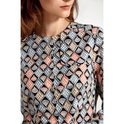 Bluzka z ozdobną klapą po lewej stronie - wzór. Bluzki damskie NIFE, xl, bez wzorów, z poliesteru, eleganckie, z klasycznym kołnierzykiem, bez rękawów. Za 139,00 zł.