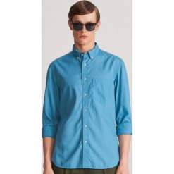 Gladka koszula regular fit - Niebieski. Niebieskie koszule męskie Reserved, xl, bez wzorów, bez kołnierzyka, bez rękawów. W wyprzedaży za 49,99 zł.