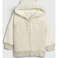 Bluza w kolorze białym. Białe bluzy niemowlęce Gap Kids, z aplikacjami, bez rękawów, bez kaptura. W wyprzedaży za 67,95 zł.