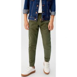 Mango Kids - Spodnie dziecięce Roland 110-164 cm. Szare spodnie chłopięce Mango Kids, bez wzorów, z bawełny, casualowe. W wyprzedaży za 49,90 zł.