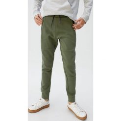Mango Kids - Spodnie dziecięce Guillem 110-164 cm. Niebieskie dresy chłopięce Mango Kids, bez wzorów, z bawełny. Za 69,90 zł.