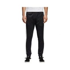 Adidas TRACKSUITS SST TP L., TRACKSUITS SST TP L. Spodnie męskie Adidas, s, bez wzorów, z dresówki, sportowe. W wyprzedaży za 406,69 zł.