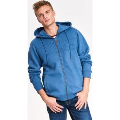 Bluza męska rozpinana z kapturem i haftowaną aplikacją. Niebieskie bluzy męskie Top Secret, na zimę, xl, z haftami, z dzianiny, z kapturem, bez rękawów, z kapturem. W wyprzedaży za 39,99 zł.