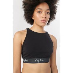 Czarny Top Daemnara. Czarne topy sportowe damskie Born2be, s, bez wzorów, bez rękawów. Za 29,99 zł.
