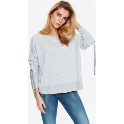 Damski sweter z taśmami na rękawach z bardzo przyjemnej dzianiny. Szare swetry damskie Top Secret, na lato, bez wzorów, z dzianiny, bez rękawów, bez kaptura. W wyprzedaży za 49,99 zł.