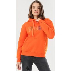 Pomarańczowa Bluza Hyrney. Pomarańczowe bluzy damskie Born2be, s, bez wzorów, bez rękawów, z kapturem. Za 79,99 zł.