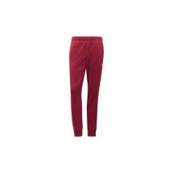 Spodnie treningowe adidas Spodnie dresowe SST. Pomarańczowe spodnie dresowe męskie marki Adidas, xl, z dresówki. Za 279,00 zł.