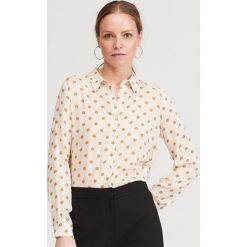 Koszula w grochy - Kremowy. Białe koszule damskie Reserved, w grochy, bez kołnierzyka, bez rękawów. W wyprzedaży za 69,99 zł.