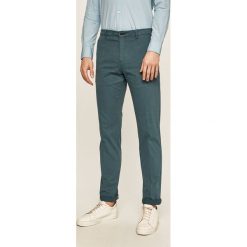 Tommy Hilfiger Tailored - Spodnie. Szare spodnie męskie Tommy Hilfiger Tailored, bez wzorów, z elastanu. W wyprzedaży za 219,90 zł.
